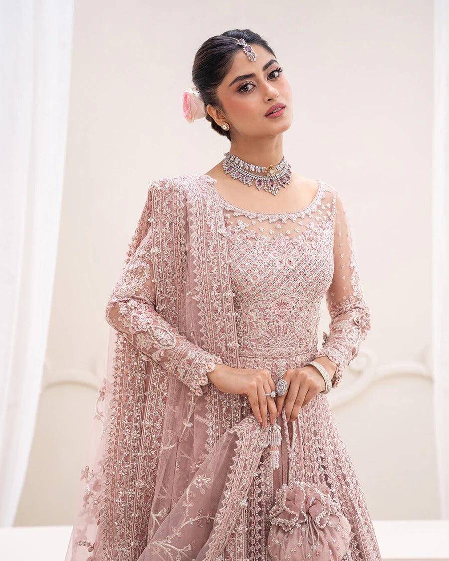 Exquisite Leyan lehenga set in dusty pink net with intricate embroidery on blouse, lehenga, and dupatta. Perfect for weddings, festive occasions, and formal events.