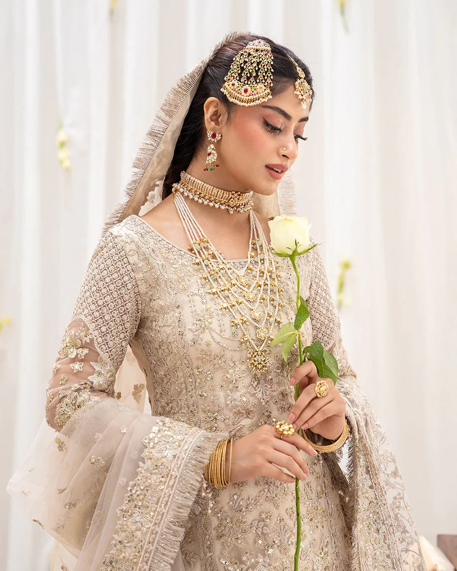 Safak ivory net gharara set with gold embroidery, featuring detailed shirt panels, embroidered dupatta, and gharara—perfect for weddings and festive celebrations.
