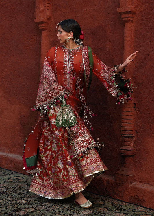 Sophisticated rust chiffon suit with intricate embroidery, bordered sleeves, Korean raw silk sharara and an embroidered chiffon dupatta with four sided borders.