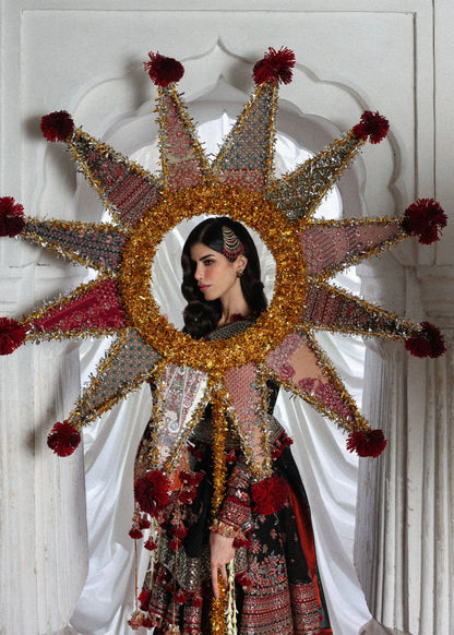 Elegant black embroidered peplum paired with flared Korean raw silk sharara and chiffon dupatta featuring delicate embroidery and four-sided borders for festive events.