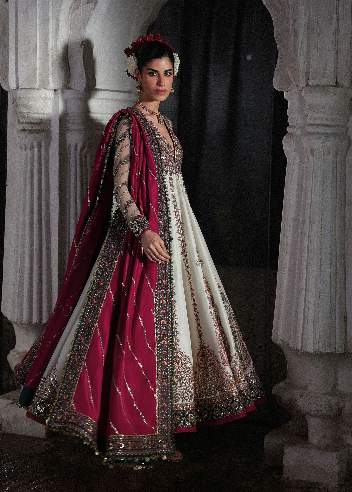 Elegant ivory embroidered pishwas with detailed panels, net sleeves, printed Korean raw silk chooridar and an embroidered Korean silk shawl for formal events.