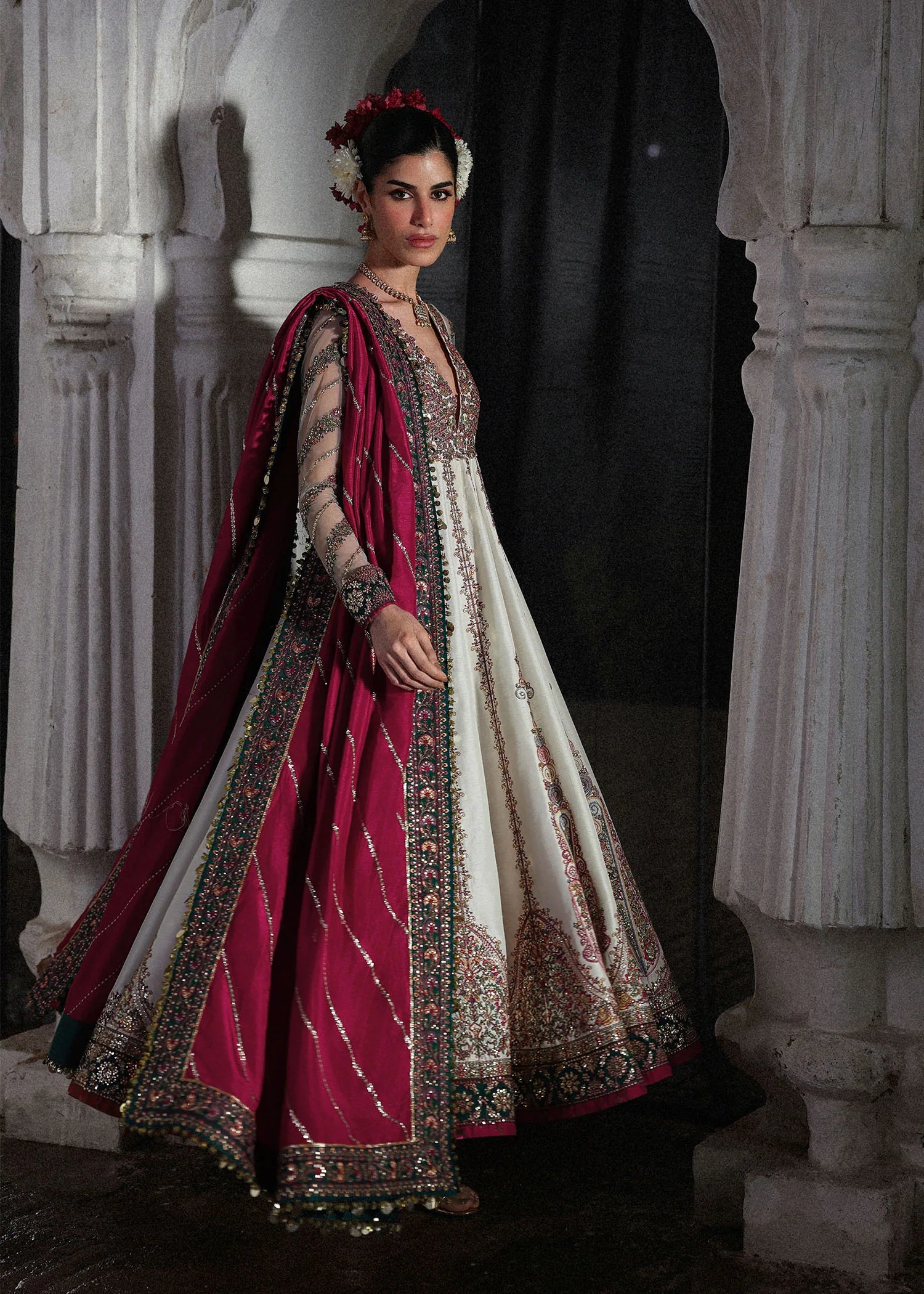 Elegant ivory embroidered pishwas with detailed panels, net sleeves, printed Korean raw silk chooridar and an embroidered Korean silk shawl for formal events.