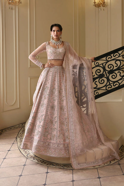 Exquisite net dress featuring hand-embellished body, sleeves, panels, and dupatta. Finished with organza kalli borders and Russian grip inner for layering.