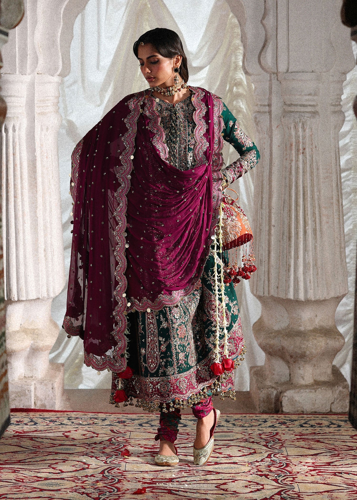 Elegant emerald green Korean raw silk suit with five panel embroidered shirt, printed chooridar and a chiffon dupatta featuring pallu and four sided borders.