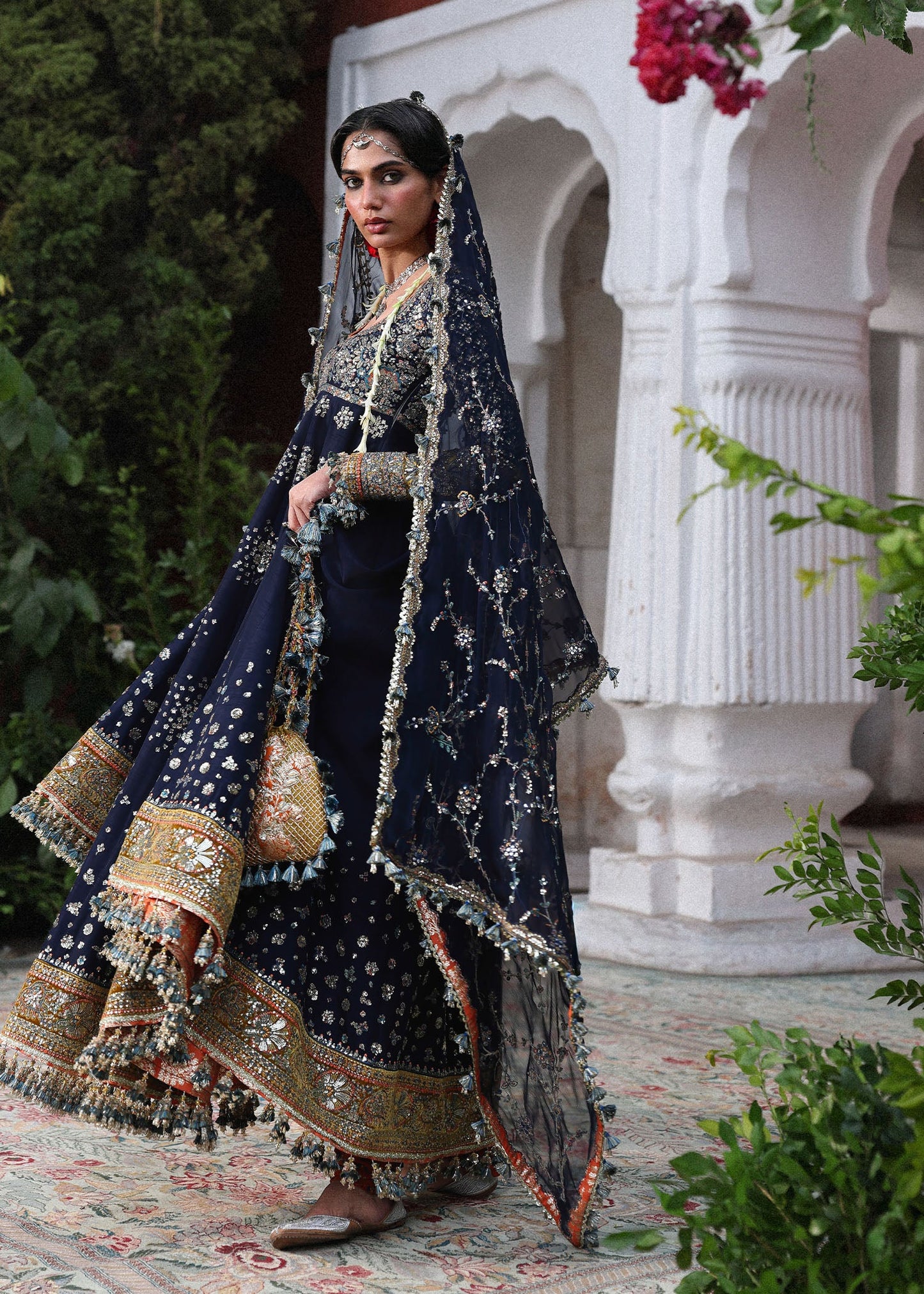 Elegant navy blue Korean raw silk pishwas with embroidered panels and sleeves, paired with printed chooridar and chiffon dupatta with four-sided borders.