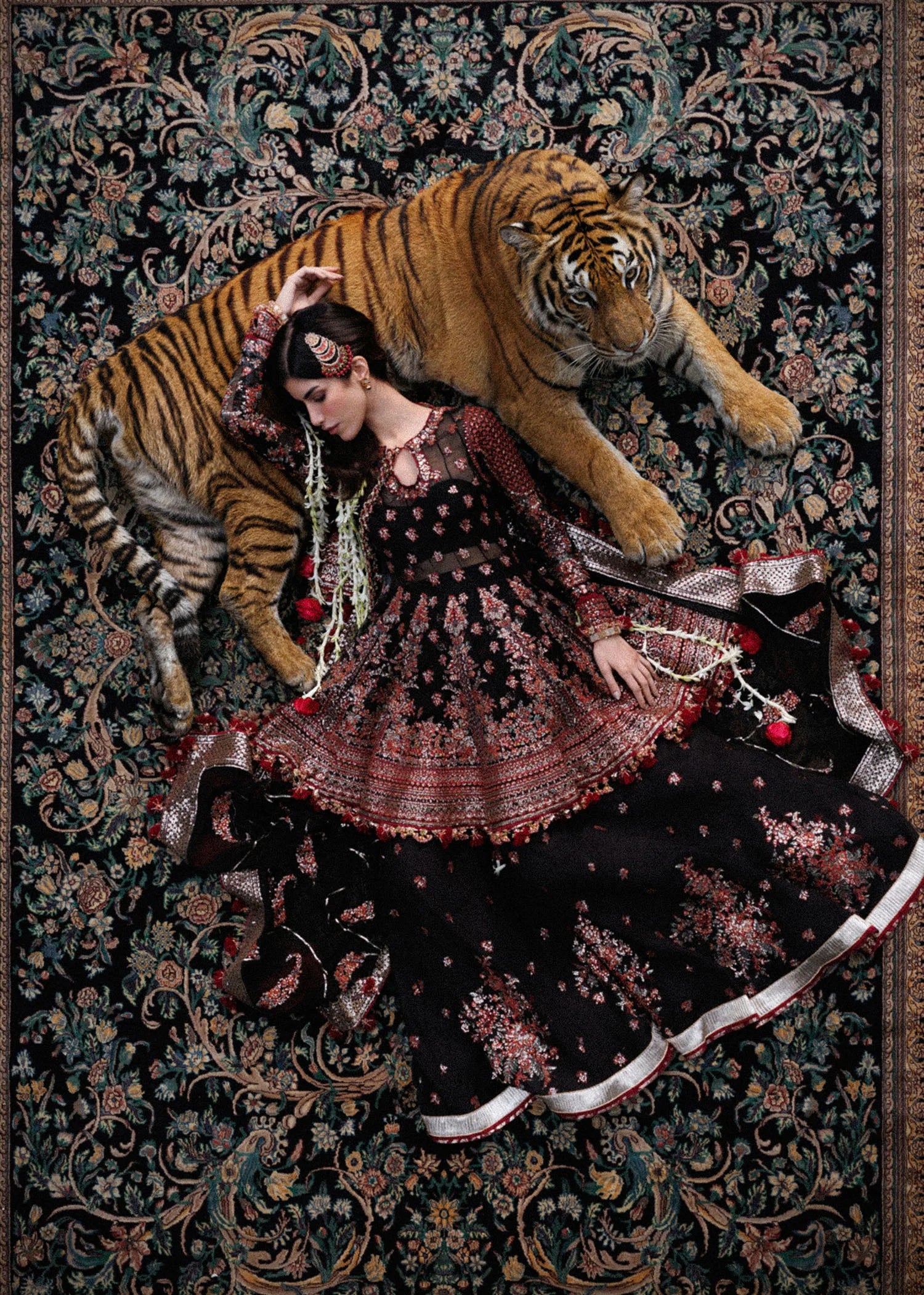 Elegant black embroidered peplum paired with flared Korean raw silk sharara and chiffon dupatta featuring delicate embroidery and four-sided borders for festive events.