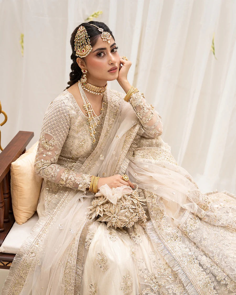 Safak ivory net gharara set with gold embroidery, featuring detailed shirt panels, embroidered dupatta, and gharara—perfect for weddings and festive celebrations.