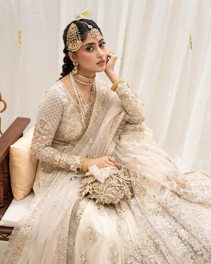 Safak ivory net gharara set with gold embroidery, featuring detailed shirt panels, embroidered dupatta, and gharara—perfect for weddings and festive celebrations.