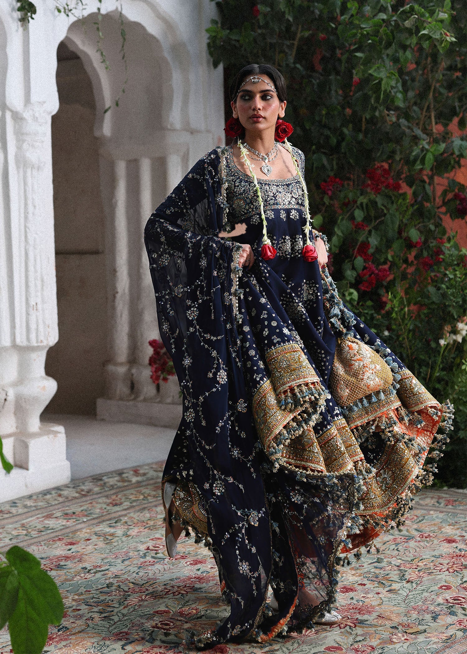 Elegant navy blue Korean raw silk pishwas with embroidered panels and sleeves, paired with printed chooridar and chiffon dupatta with four-sided borders.