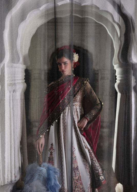 Elegant ivory embroidered pishwas with detailed panels, net sleeves, printed Korean raw silk chooridar and an embroidered Korean silk shawl for formal events.