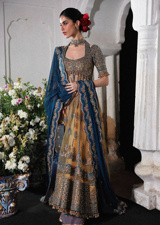 Graceful butter yellow net pishwas with embroidered panels and sleeves, paired with printed Korean raw silk sharara and a chiffon dupatta with borders.