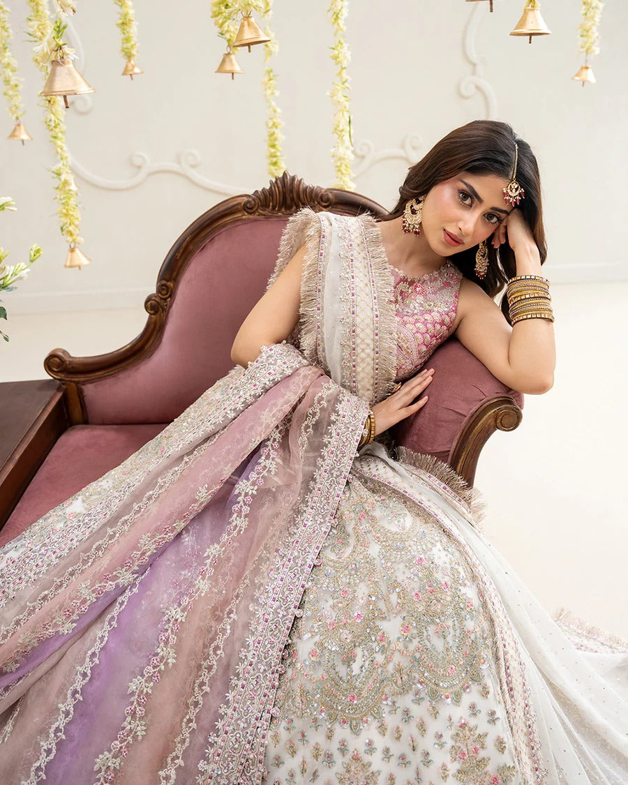 Elegant Suzan lehnga set in blush pink featuring a delicately embroidered tissue blouse, voluminous net skirt, and contrasting organza dupatta—perfect for festive occasions.