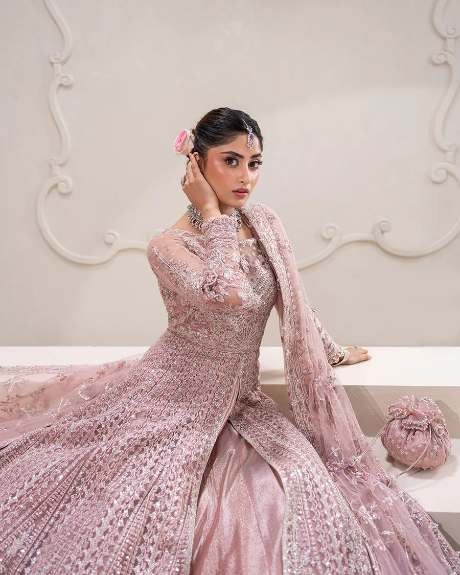 Exquisite Leyan lehenga set in dusty pink net with intricate embroidery on blouse, lehenga, and dupatta. Perfect for weddings, festive occasions, and formal events.