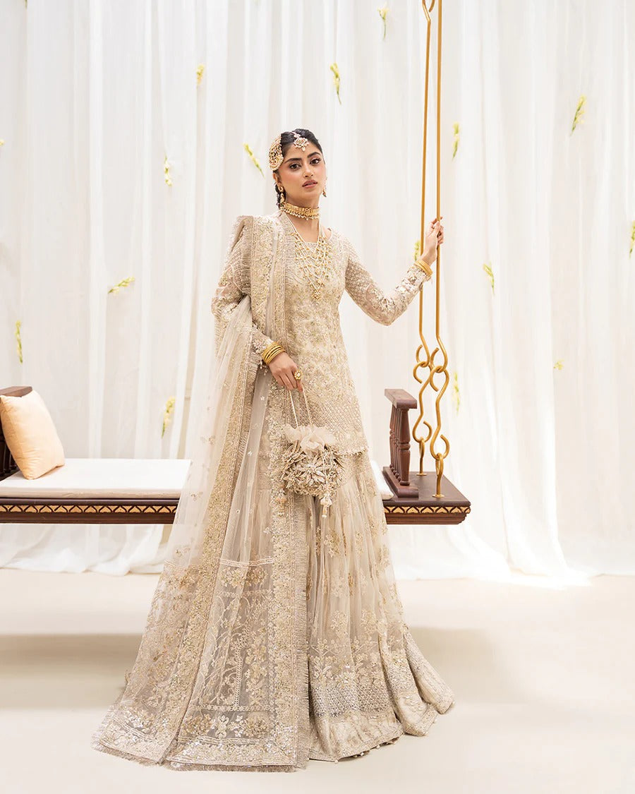 Safak ivory net gharara set with gold embroidery, featuring detailed shirt panels, embroidered dupatta, and gharara—perfect for weddings and festive celebrations.