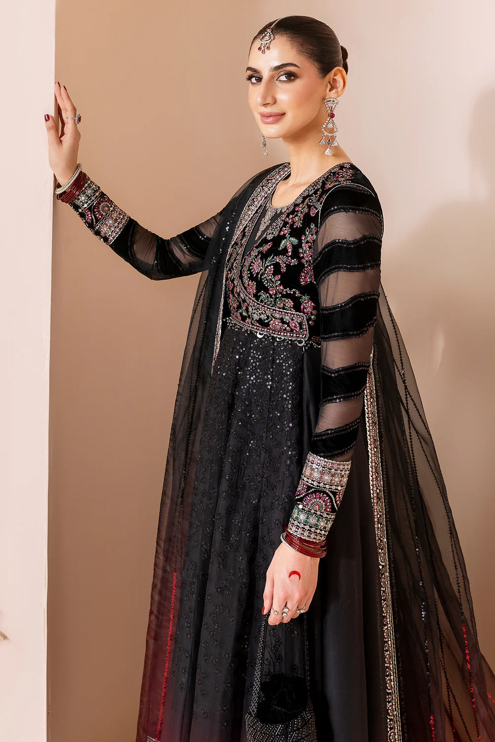 Elegant formal suit with embroidered velvet, laser-embellished chiffon sleeves, and digital printed chiffon panels. Includes digital organza dupatta & silk lining.