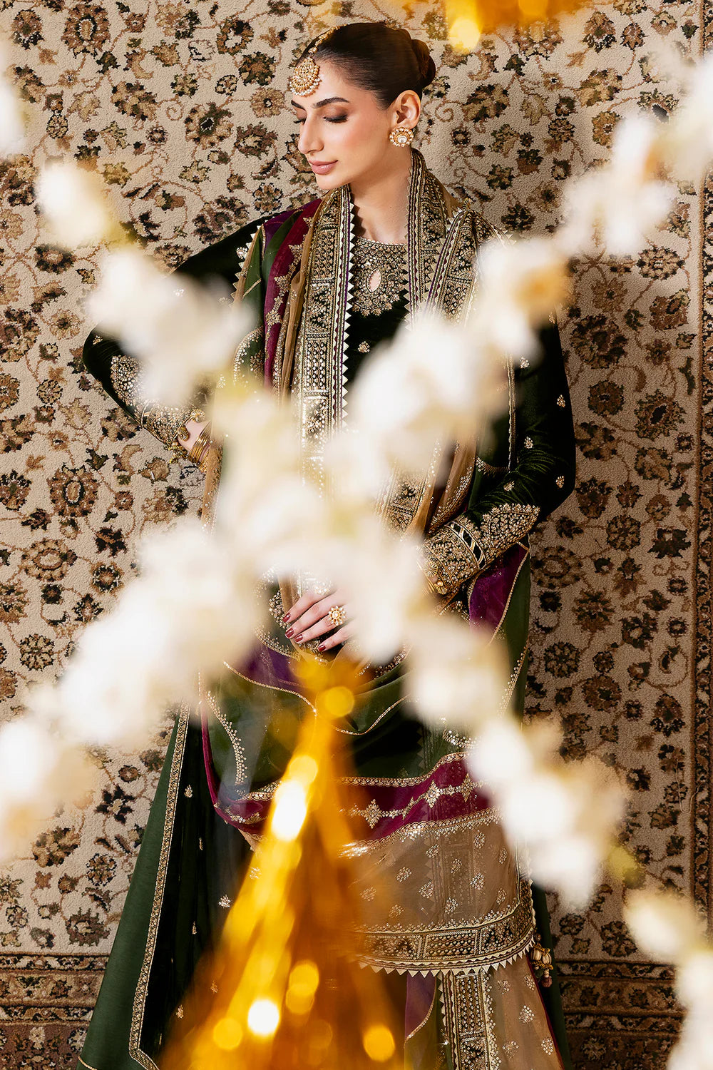 Luxurious velvet suit with intricate embroidery, dyed raw silk bottom, and embroidered organza dupatta. Perfect for formal occasions with timeless elegance.