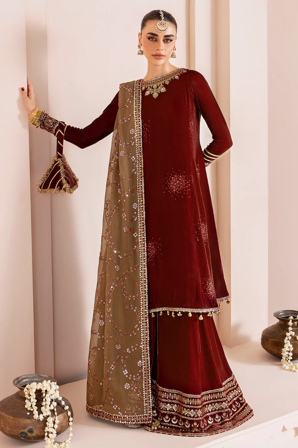 Luxurious pure velvet suit with intricate embroidery on panels, sleeves & borders. Includes embroidered georgette chiffon dupatta for a refined formal look.