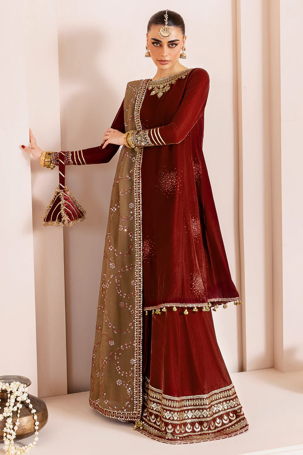 Luxurious pure velvet suit with intricate embroidery on panels, sleeves & borders. Includes embroidered georgette chiffon dupatta for a refined formal look.