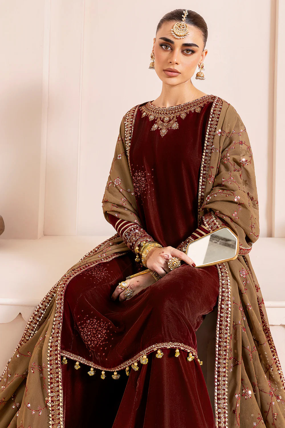 Luxurious pure velvet suit with intricate embroidery on panels, sleeves & borders. Includes embroidered georgette chiffon dupatta for a refined formal look.