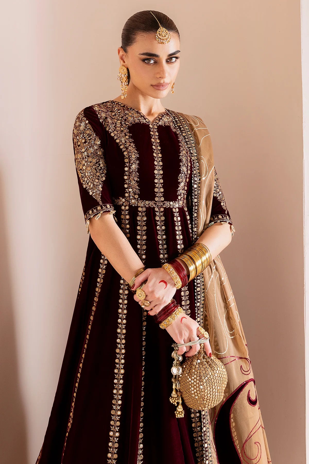 Luxurious velvet formal dress with intricate embroidery, organza dupatta, and silk crushed bottom. A timeless unstitched outfit for elegant evening wear.