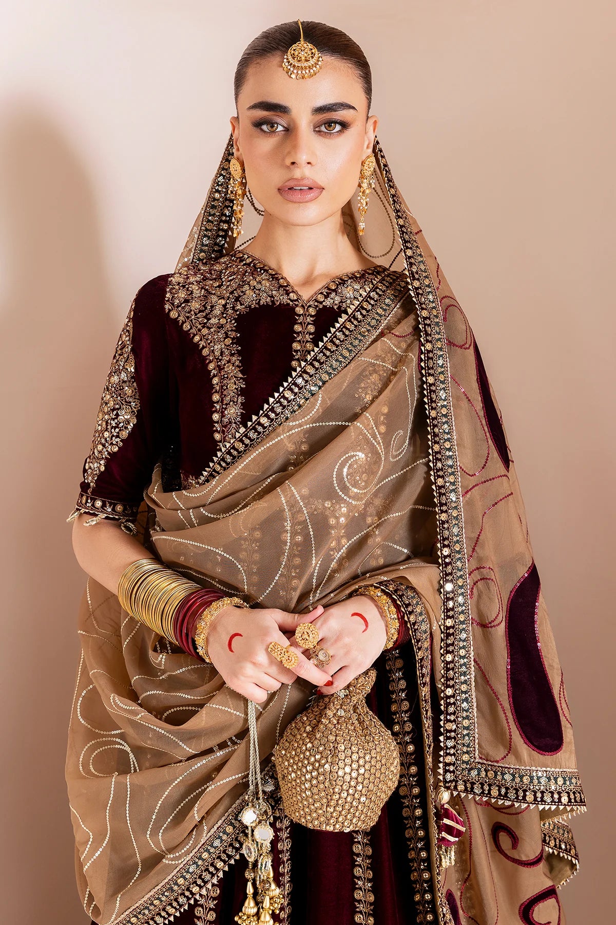 Luxurious velvet formal dress with intricate embroidery, organza dupatta, and silk crushed bottom. A timeless unstitched outfit for elegant evening wear.