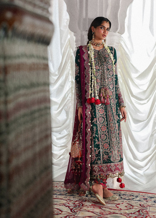 Elegant emerald green Korean raw silk suit with five panel embroidered shirt, printed chooridar and a chiffon dupatta featuring pallu and four sided borders.