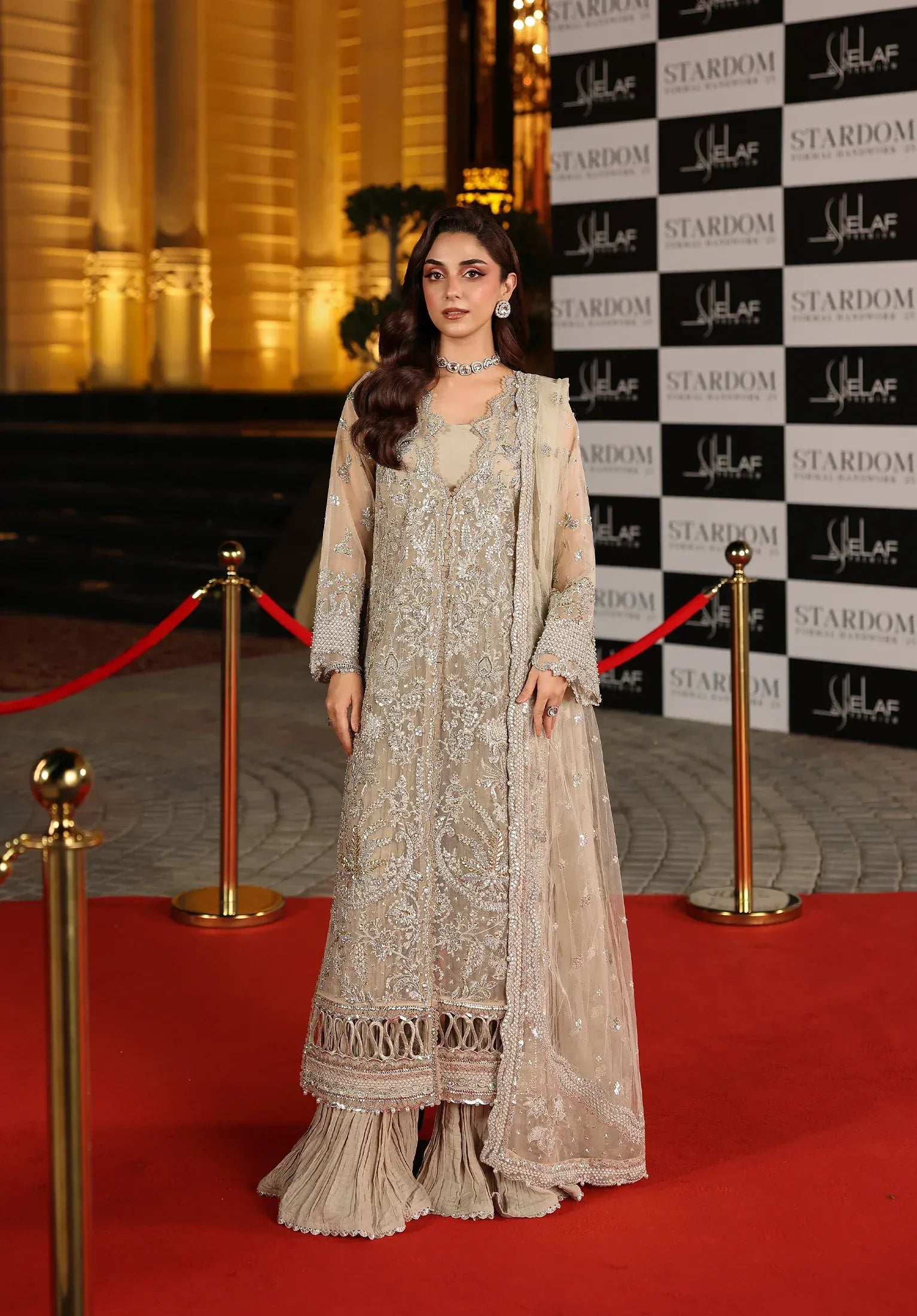 Stardust by Elaf Stardom ’25 features hand-embroidered organza panels, embroidered poly-net dupatta, and raw silk inner — ideal for festive and formal elegance.