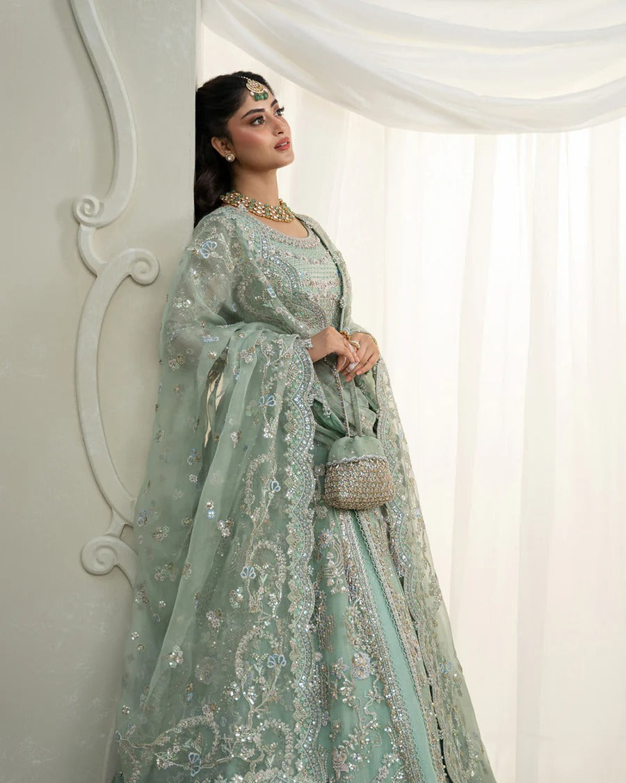 Selin lehenga set in mint green organza with heritage embroidery, paired with raw silk skirt and embroidered dupatta—perfect for weddings and festive celebrations.