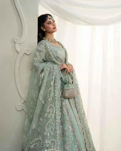 Selin lehenga set in mint green organza with heritage embroidery, paired with raw silk skirt and embroidered dupatta—perfect for weddings and festive celebrations.
