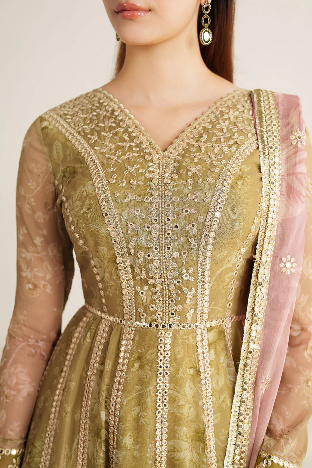 Graceful embroidered chiffon ensemble with printed sleeves, dupatta borders, and raw silk bottom. Elegant, lightweight design perfect for formal wear events.