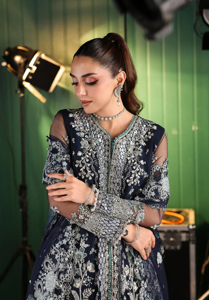 Skyfall by Elaf Stardom ’25 features hand-embroidered poly-net panels, detailed dupatta, and raw silk inner — perfect for formal evenings and festive elegance.