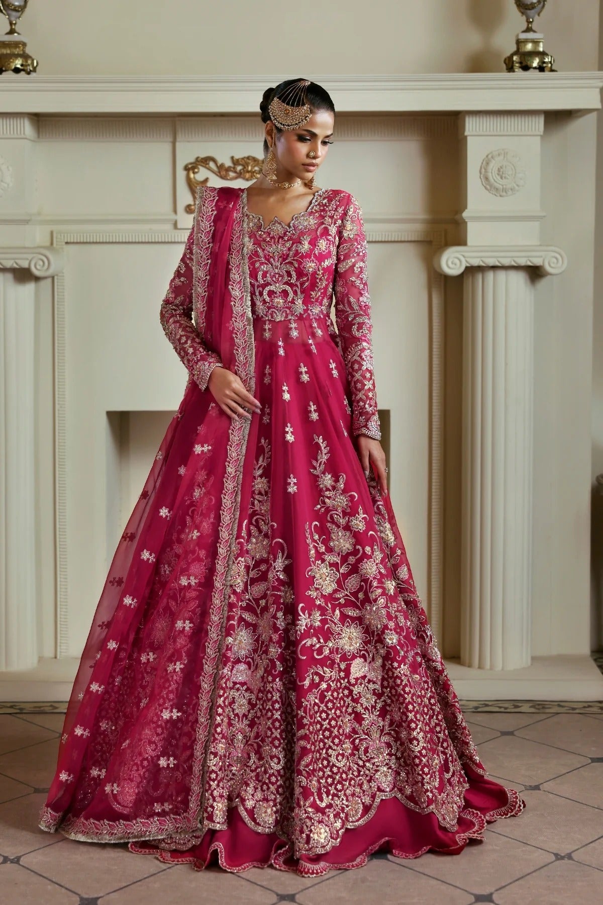 Opulent organza ensemble with hand-embellished panels, embroidered dupatta, lehenga border, Russian grip inner, and raw silk lehenga fabric. Ideal for events.
