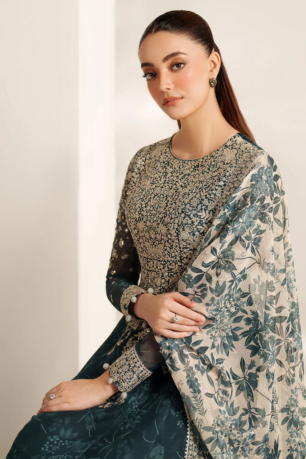 Elegant embroidered chiffon ensemble with printed yoke and panels, delicate sleeve borders, flowing back, embroidered dupatta, and raw silk bottom for timeless style.