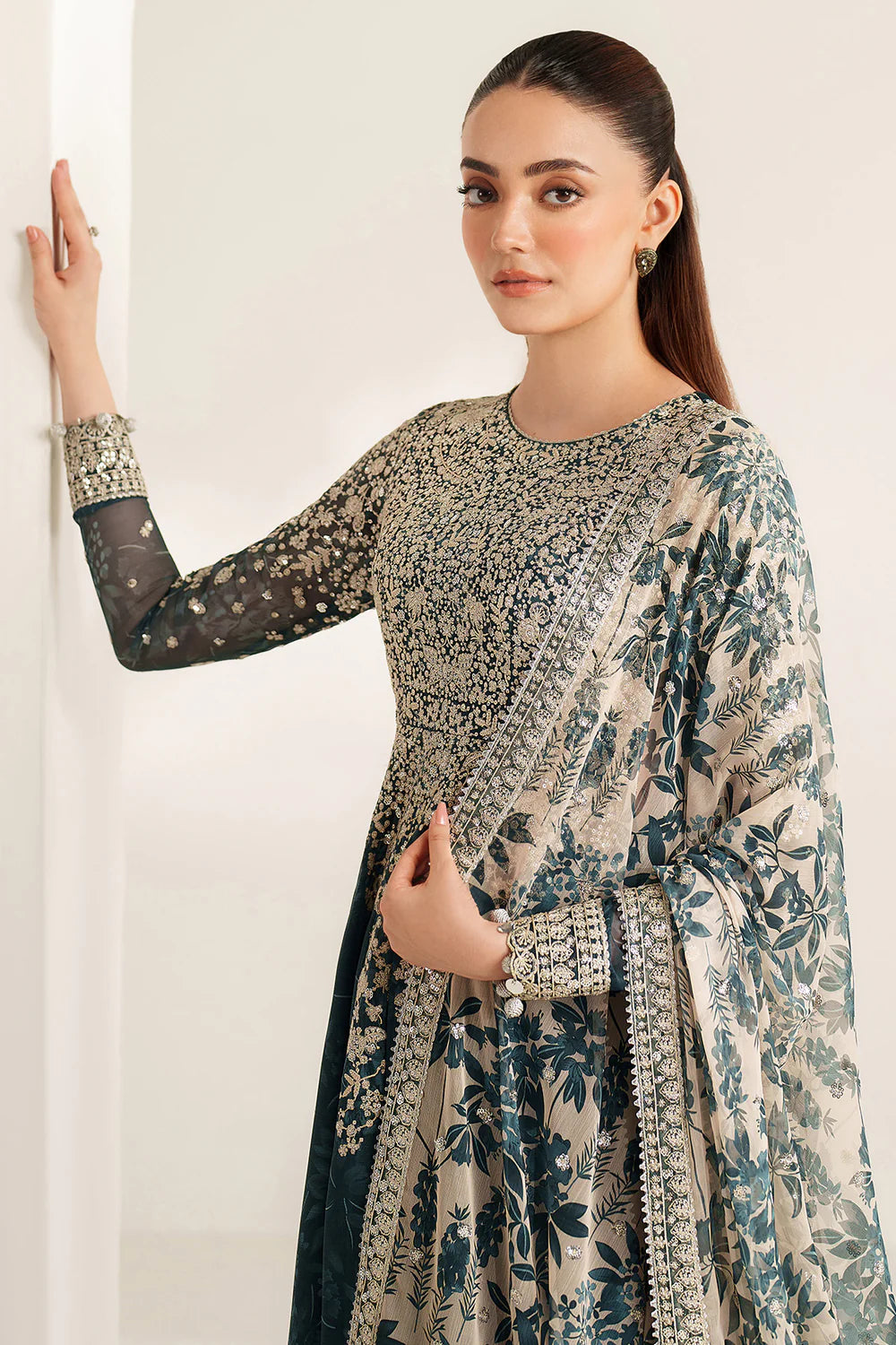 Elegant embroidered chiffon ensemble with printed yoke and panels, delicate sleeve borders, flowing back, embroidered dupatta, and raw silk bottom for timeless style.