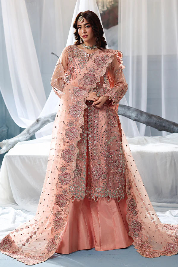 Peach organza unstitched suit with fine embroidery, raw silk shahrara and artistic dupatta, designed for elegant festive and evening wear occasions.