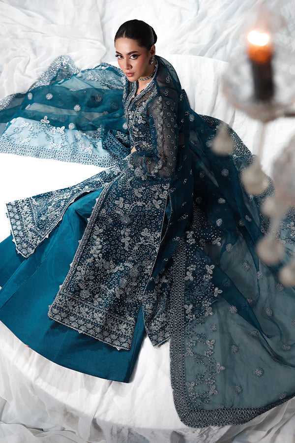 Deep teal organza unstitched suit with silver embroidery, raw silk shahrara and embroidered dupatta, designed for women who love timeless elegance wear.