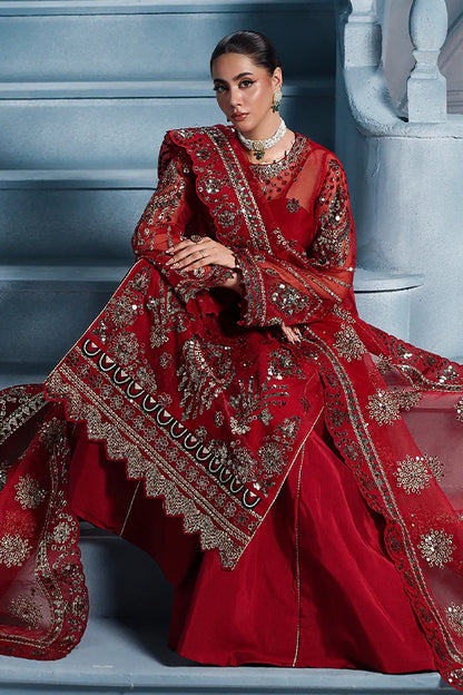 Scarlet red organza unstitched suit with artisanal embroidery, raw silk shahrara and lavishly embellished dupatta pallus for regal festive wear.