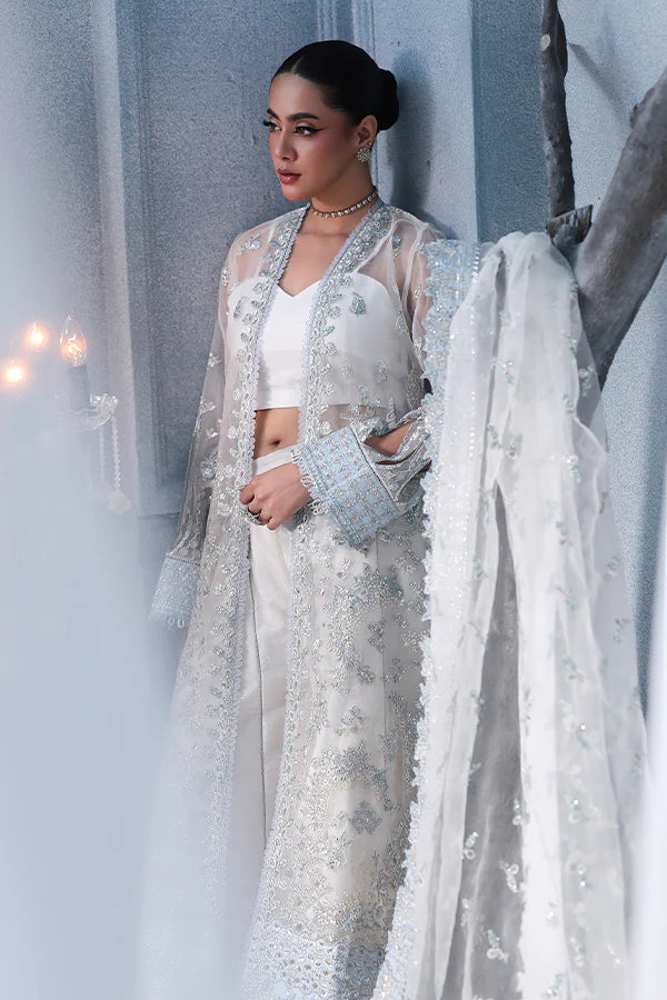 Off-white ivory organza unstitched suit with fine threadwork, contrast silk borders, raw silk shahrara and embellished dupatta for elegant festive wear.