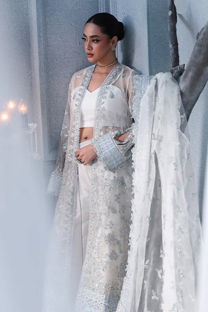 Off-white ivory organza unstitched suit with fine threadwork, contrast silk borders, raw silk shahrara and embellished dupatta for elegant festive wear.