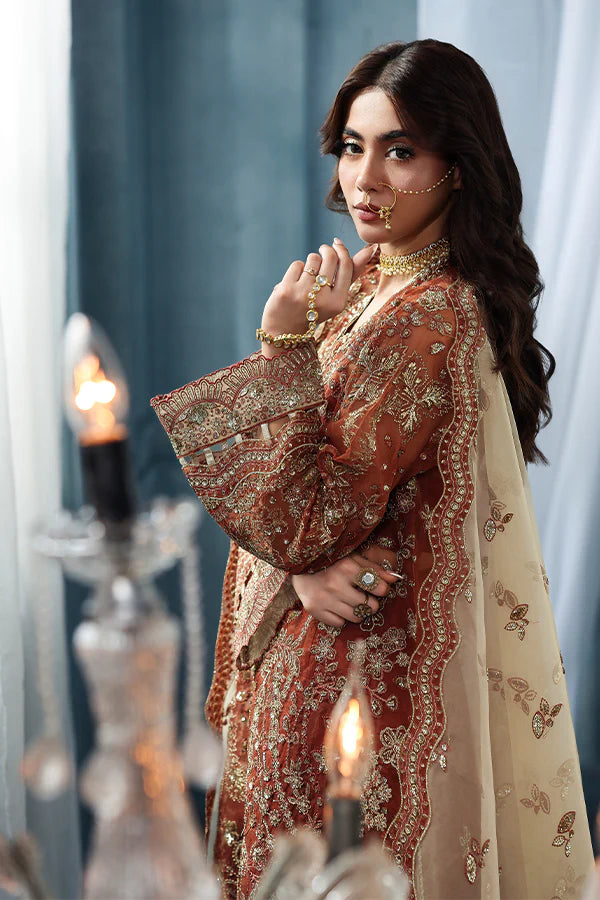 Burnt orange organza unstitched suit with artisan embroidery, raw silk shahrara and contrast dupatta with embellished pallu for regal festive wear look.