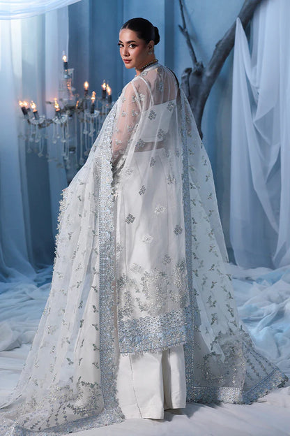 Off-white ivory organza unstitched suit with fine threadwork, contrast silk borders, raw silk shahrara and embellished dupatta for elegant festive wear.