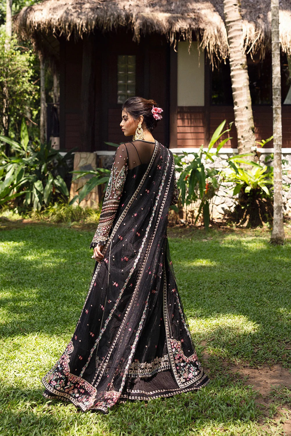 Elegant black 3-piece unstitched set in organza & net with hand and machine embroidery, including raw silk trouser and dupatta, perfect for weddings and festive events.
