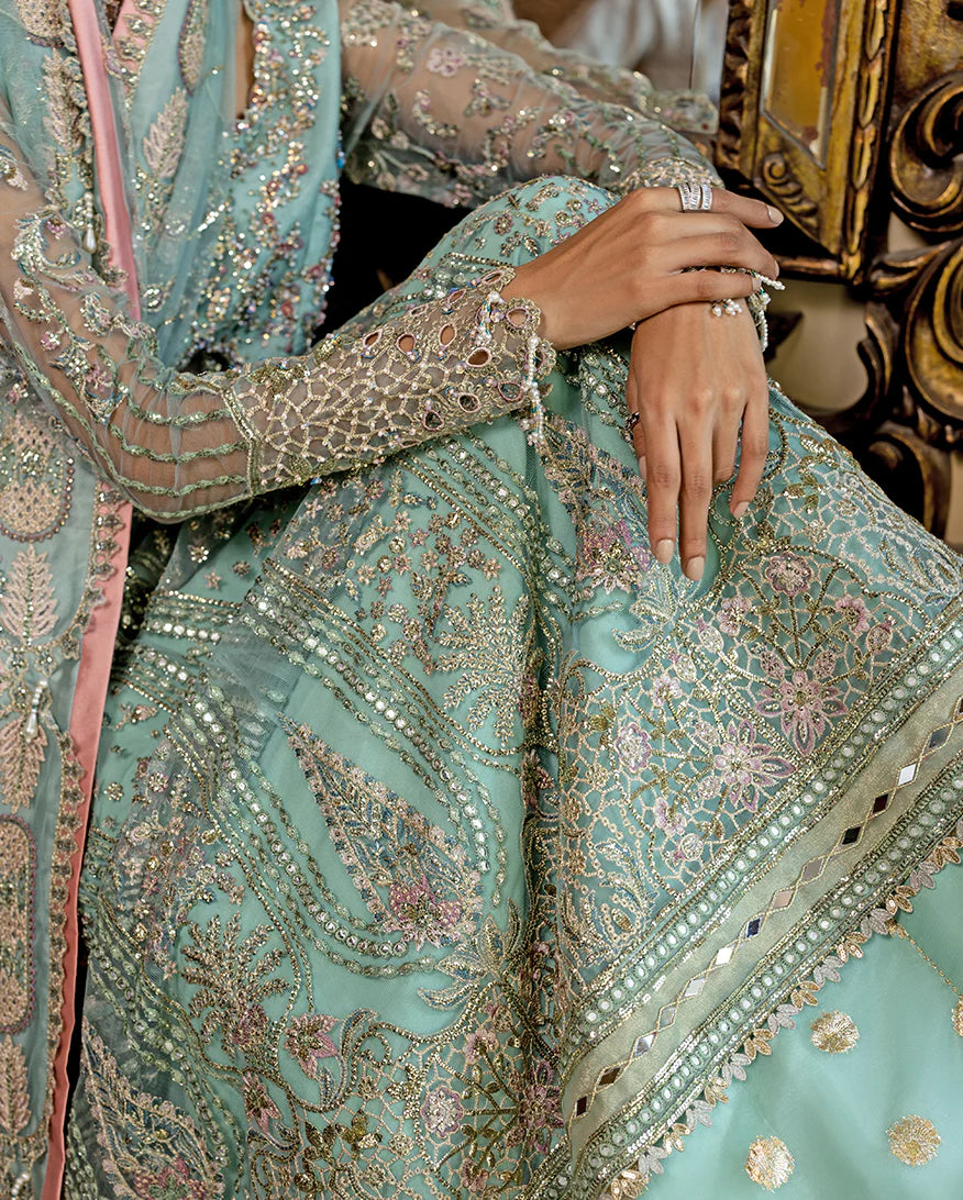 Luxury wedding formal featuring hand-embroidered sequined net shirt, raw silk lehenga, sequined dupatta, and exquisite mirror, golden, and organza lace finishes.