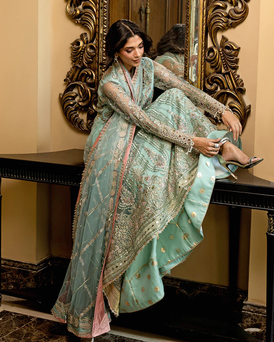 Luxury wedding formal featuring hand-embroidered sequined net shirt, raw silk lehenga, sequined dupatta, and exquisite mirror, golden, and organza lace finishes.
