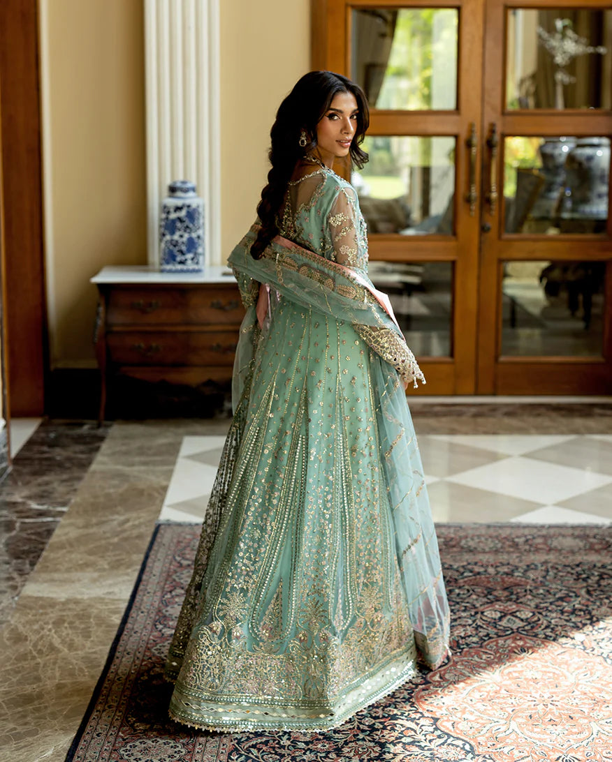 Luxury wedding formal featuring hand-embroidered sequined net shirt, raw silk lehenga, sequined dupatta, and exquisite mirror, golden, and organza lace finishes.