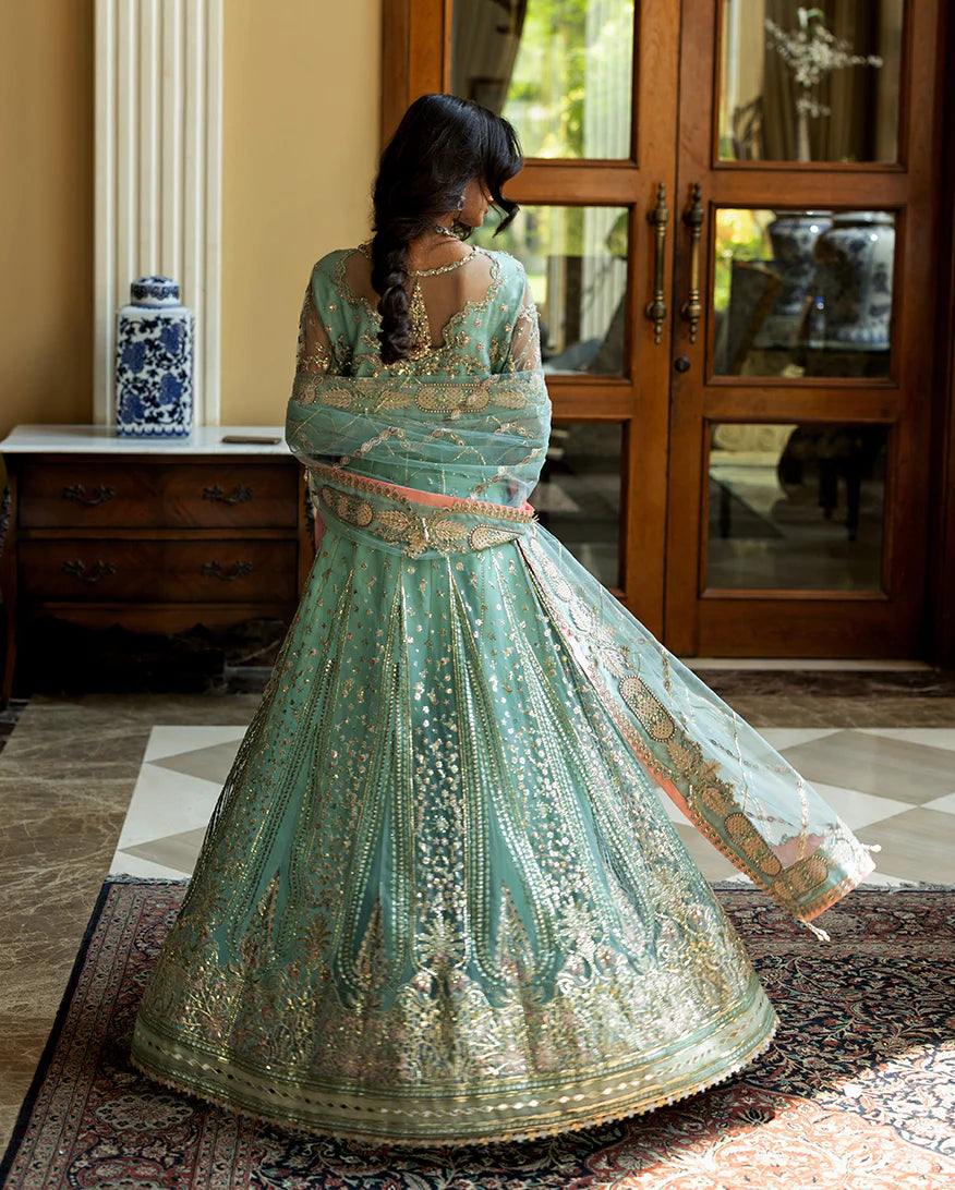 Luxury wedding formal featuring hand-embroidered sequined net shirt, raw silk lehenga, sequined dupatta, and exquisite mirror, golden, and organza lace finishes.