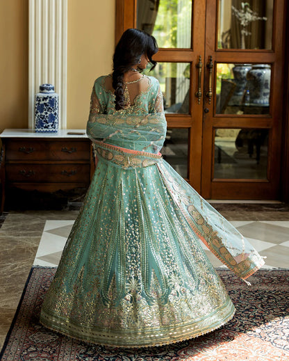 Luxury wedding formal featuring hand-embroidered sequined net shirt, raw silk lehenga, sequined dupatta, and exquisite mirror, golden, and organza lace finishes.