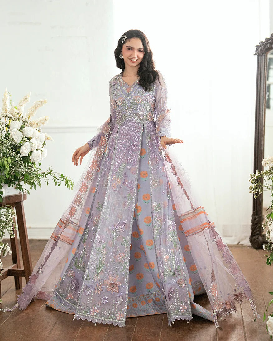 Shop this chiffon suit with hand embellishments, 3D florals, sequinned net dupatta & printed silk trouser. Includes tassels, lace & pearl detailing.