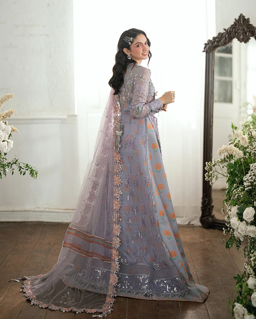 Shop this chiffon suit with hand embellishments, 3D florals, sequinned net dupatta & printed silk trouser. Includes tassels, lace & pearl detailing.