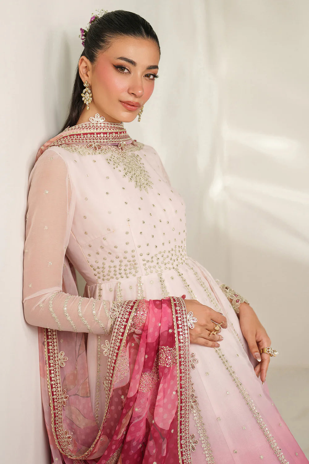 Expertly crafted embroidered chiffon ensemble with digitally printed yoke, panels, sleeves, detailed borders, elegant dupatta, and dyed raw silk bottom.